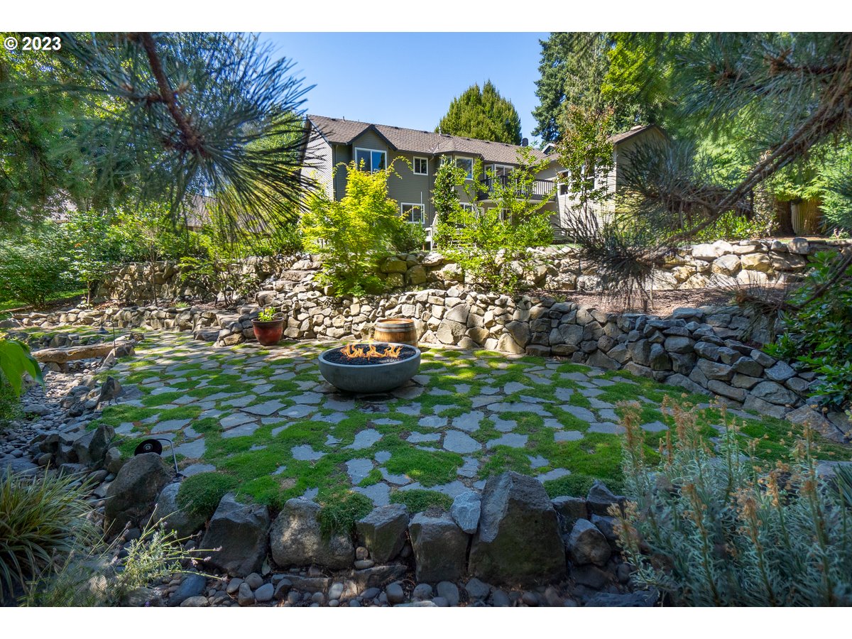8580 Southwest Thoroughbred Place Beaverton, OR 97008 - Photo 40 of 43 a view of a backyard with plants and a fountain