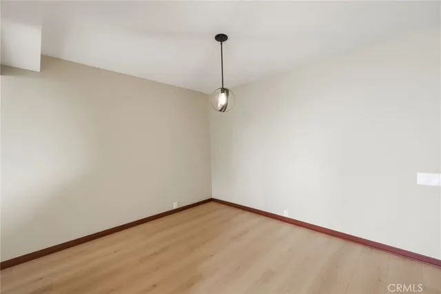 a view of a room with wooden floor and windows