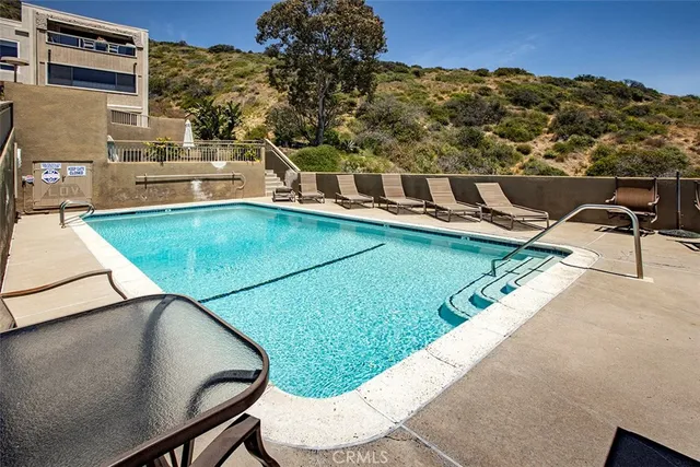 a front view of a house with outdoor seating space and potted plants