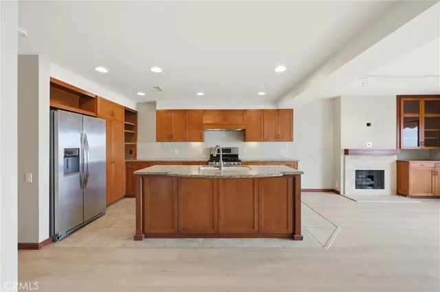 a large kitchen with stainless steel appliances a large counter top