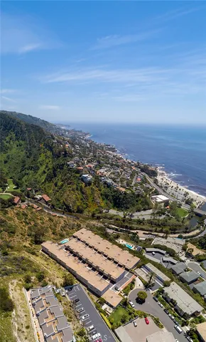 an aerial view of ocean with residential house and outdoor space