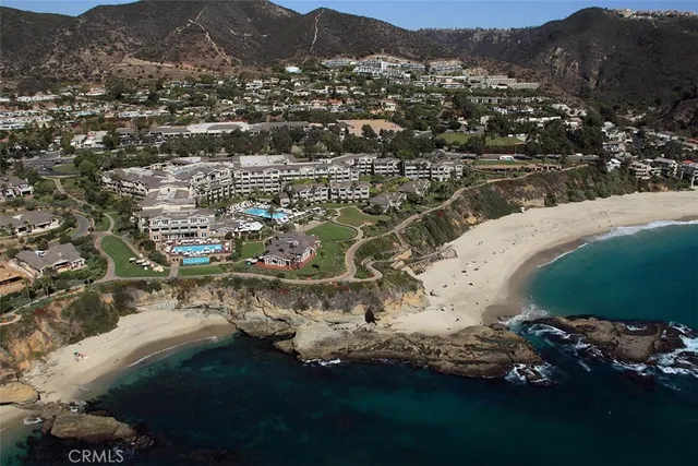 an aerial view of a house with a mountain