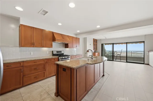 a kitchen with stainless steel appliances granite countertop a sink and cabinets