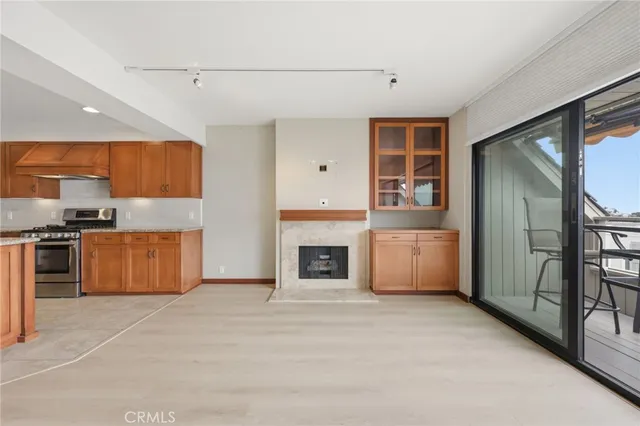 a kitchen with granite countertop a stove top oven and refrigerator