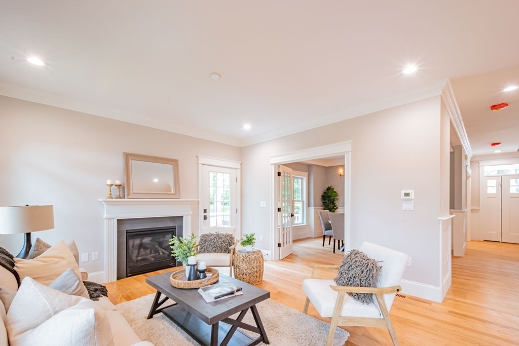 18 Pine Knoll Road Lexington, MA 02420 - Photo 13 of 42 a living room with furniture a fireplace and a table