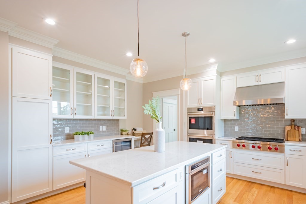 18 Pine Knoll Road Lexington, MA 02420 - Photo 17 of 42 a kitchen with a stove a sink a refrigerator and chairs