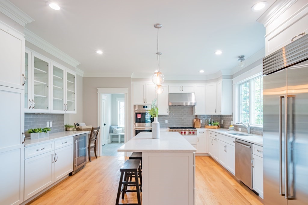 18 Pine Knoll Road Lexington, MA 02420 - Photo 20 of 42 a kitchen with kitchen island a sink a center island stainless steel appliances and cabinets