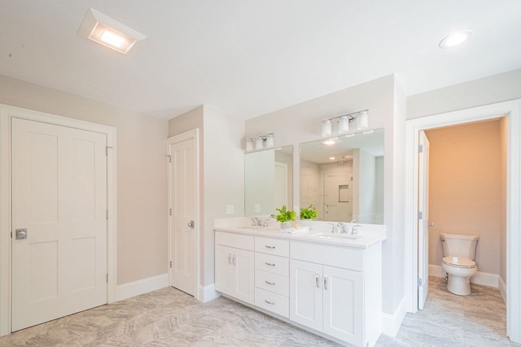 18 Pine Knoll Road Lexington, MA 02420 - Photo 28 of 42 a spacious bathroom with a granite countertop sink mirror and a toilet