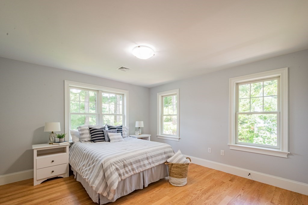 18 Pine Knoll Road Lexington, MA 02420 - Photo 31 of 42 a spacious bedroom with a bed and a window