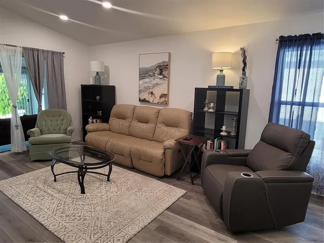 a living room with furniture and a lamp