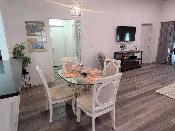 a dining room with furniture and wooden floor