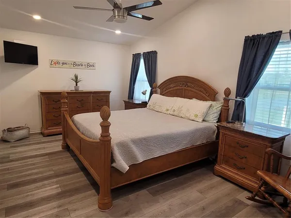 a bedroom with a bed and a television