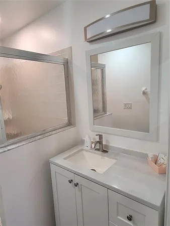 a bathroom with a sink and a mirror