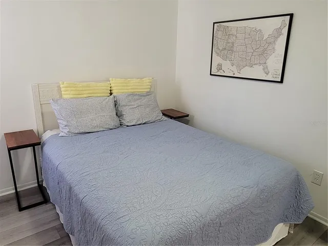a large bed sitting in a bedroom next to a small wall