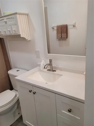 a bathroom with a sink toilet and mirror