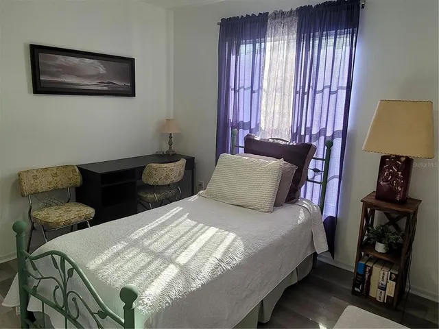 a bedroom with bed and a window