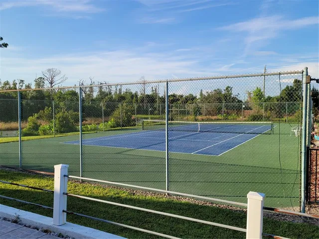 a view of a room with wooden floor and fence