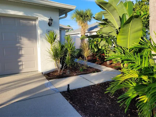 a front view of a house with a plants