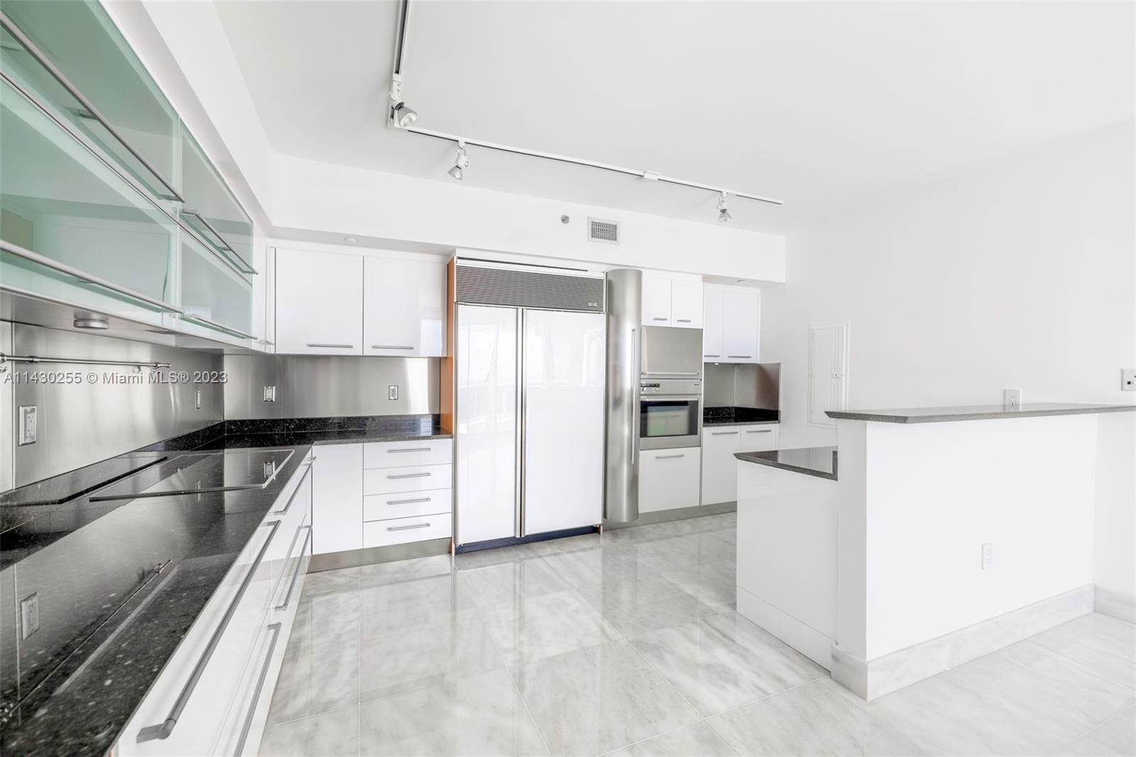 400 Alton Road, Unit 3403 Miami Beach, FL 33139 - Photo 20 of 34 a kitchen with stainless steel appliances a refrigerator and a stove top oven