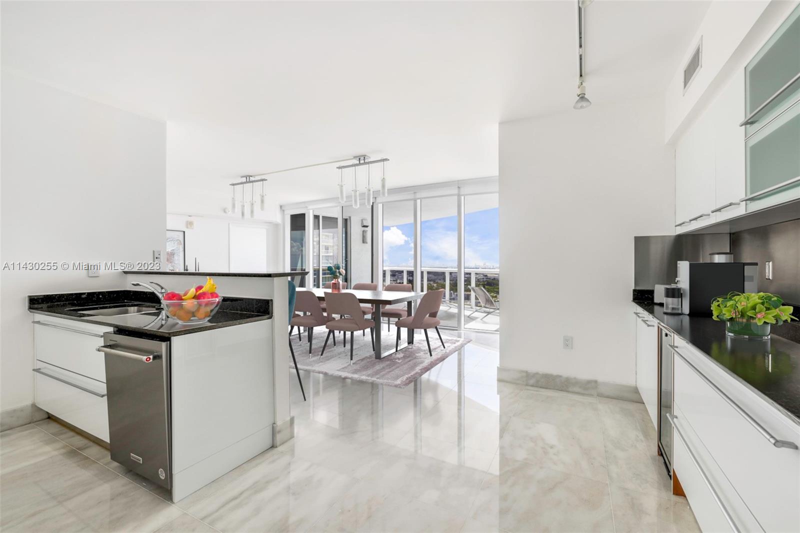 400 Alton Road, Unit 3403 Miami Beach, FL 33139 - Photo 4 of 34 a kitchen with a table and chairs