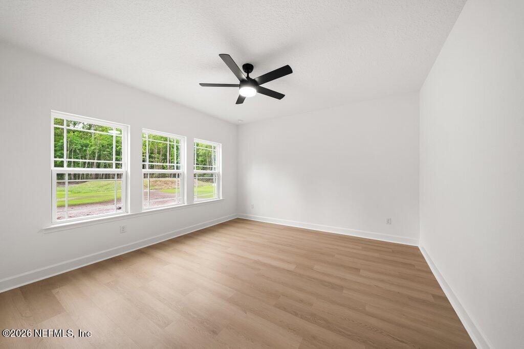 2318 Steel Bridge Road Macclenny, FL 32063 - Photo 21 of 39 an empty room with wooden floor and windows