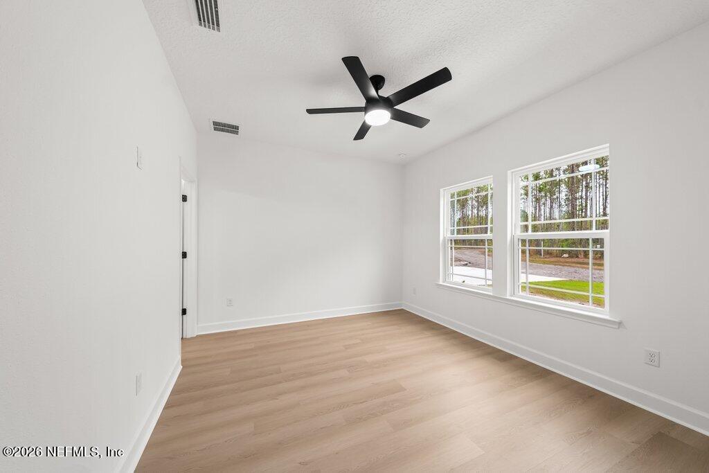 2318 Steel Bridge Road Macclenny, FL 32063 - Photo 25 of 39 wooden floor in an empty room with a window