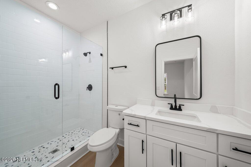 2318 Steel Bridge Road Macclenny, FL 32063 - Photo 27 of 39 a bathroom with a sink a toilet and shower