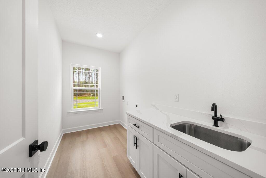 2318 Steel Bridge Road Macclenny, FL 32063 - Photo 28 of 39 a hallway with a sink and a window