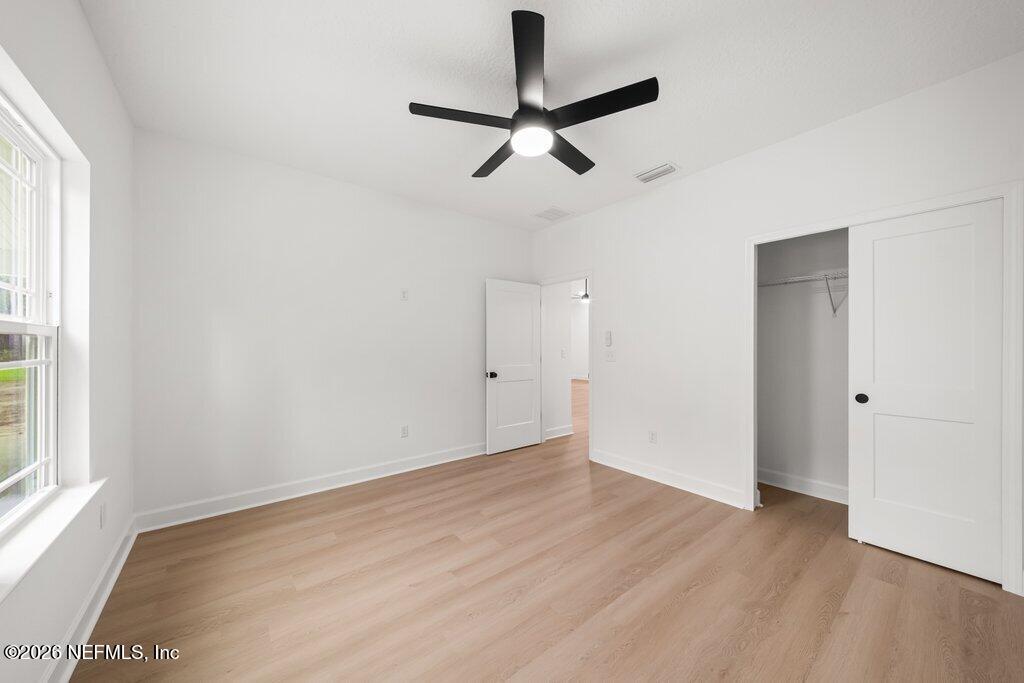 2318 Steel Bridge Road Macclenny, FL 32063 - Photo 30 of 39 wooden floor in an empty room with a window