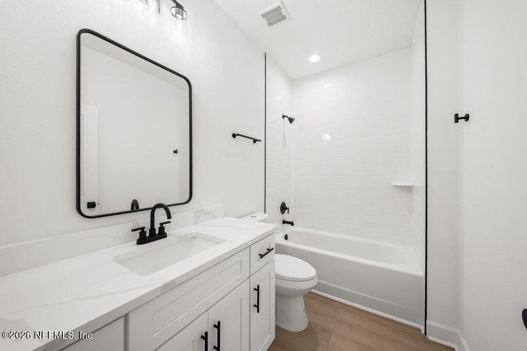 2318 Steel Bridge Road Macclenny, FL 32063 - Photo 31 of 39 a bathroom with a sink mirror toilet and bathtub