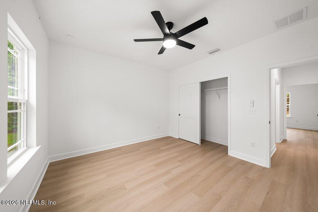 2318 Steel Bridge Road Macclenny, FL 32063 - Photo 33 of 39 wooden floor in an empty room with a window