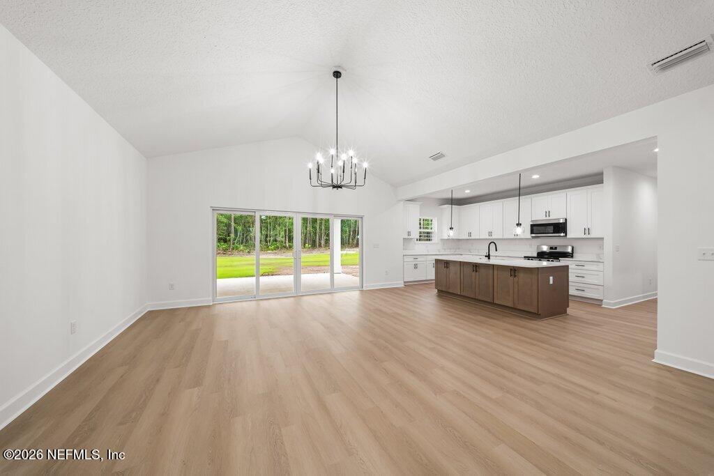 2318 Steel Bridge Road Macclenny, FL 32063 - Photo 7 of 39 a view of an empty room with window and wooden floor