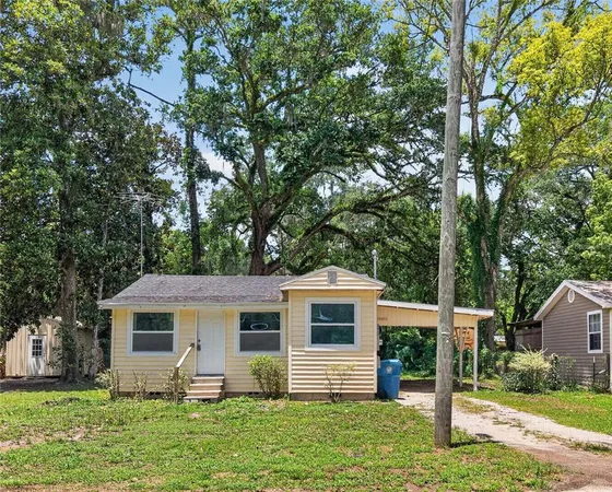 a front view of house with yard and green space