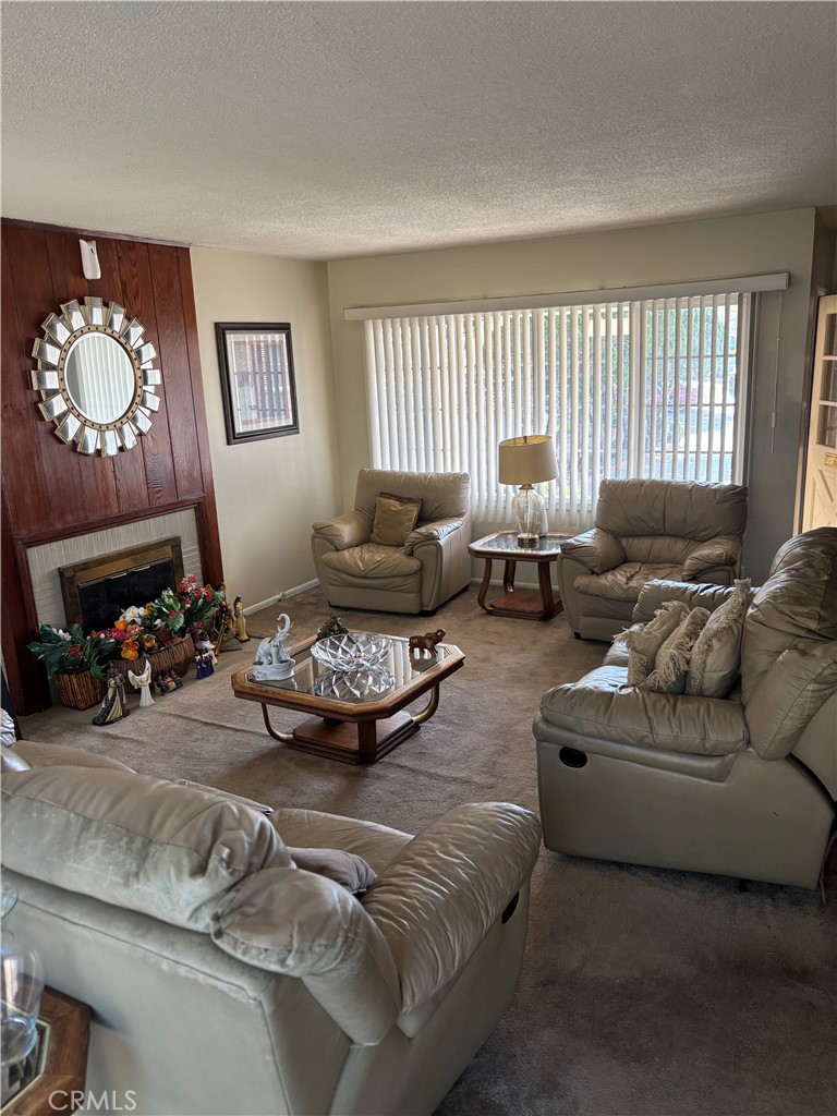 2403 West 116th Street Hawthorne, CA 90250 - Photo 12 of 15 a living room with furniture a fireplace and a window