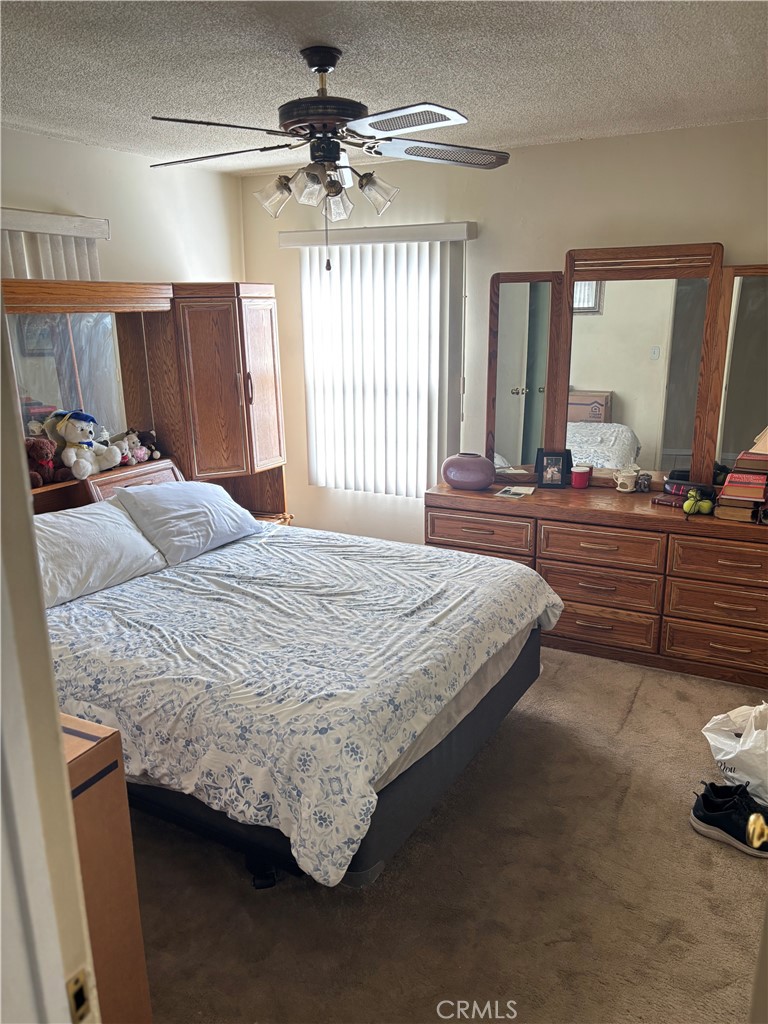 2403 West 116th Street Hawthorne, CA 90250 - Photo 2 of 15 a bedroom with a bed and a large mirror on the dresser