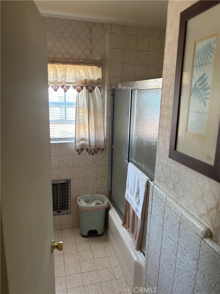 2403 West 116th Street Hawthorne, CA 90250 - Photo 10 of 15 a bathroom with a granite countertop sink and a mirror