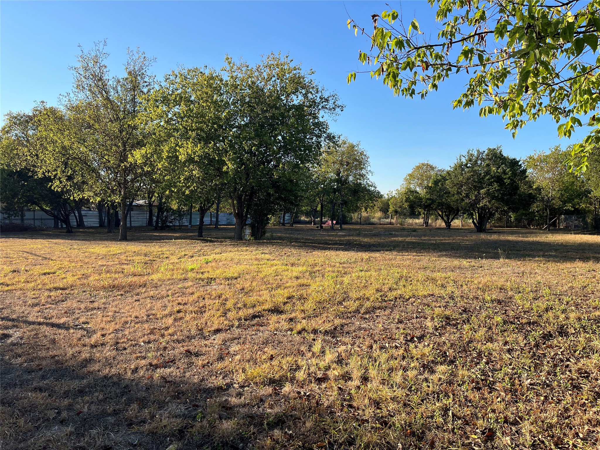 25 Cortez Street Kyle, TX 78640 - Photo 1 of 13 View of yard featuring a view of countryside and view of wooded area