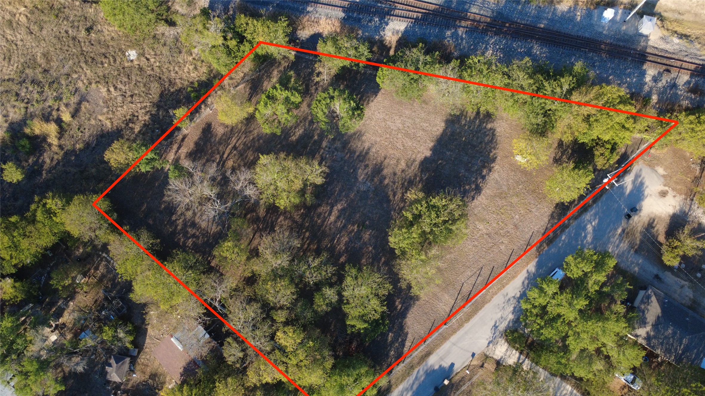 25 Cortez Street Kyle, TX 78640 - Photo 2 of 13 Aerial view of property and surrounding area with property parcel outlined