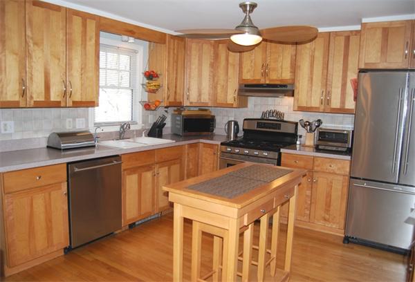 49 Dix Rd Extension Woburn, MA 01801 - Photo 6 of 19 a kitchen with a refrigerator a stove a sink dishwasher and wooden cabinets with wooden floor