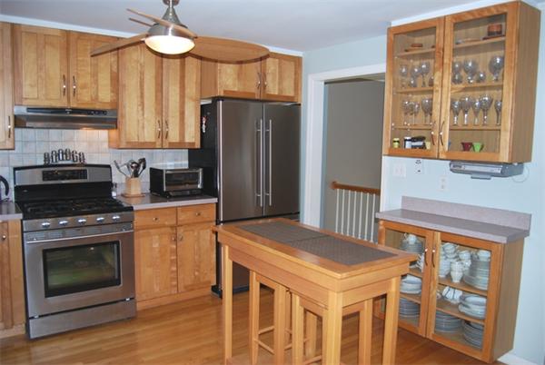 49 Dix Rd Extension Woburn, MA 01801 - Photo 7 of 19 a kitchen with stainless steel appliances granite countertop a stove a refrigerator and a stove top oven
