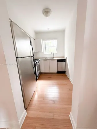 a room with window and refrigerator