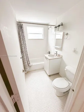 a bathroom with a toilet a sink and a mirror