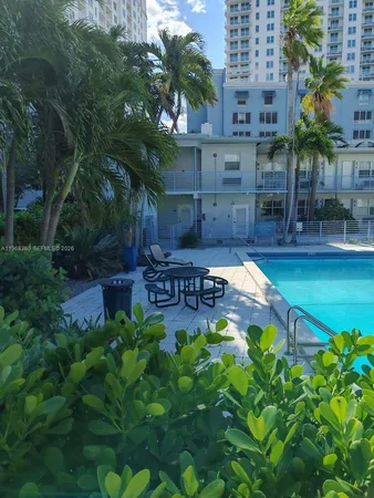 a backyard of a house with lots of green space and fountain in the back