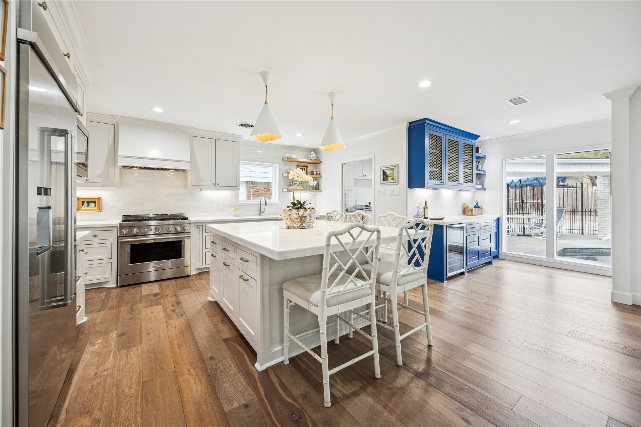 7906 Meadowbriar Lane Houston, TX 77063 - Photo 34 of 34 The stunning kitchen was fully remodeled in 2021, creating an open floor plan while maintaining elevated character and adding ample storage. The kitchen features high-end KitchenAid appliances, including a built-in 48-inch fridge, farmhouse sink, gas range and built-in microwave.