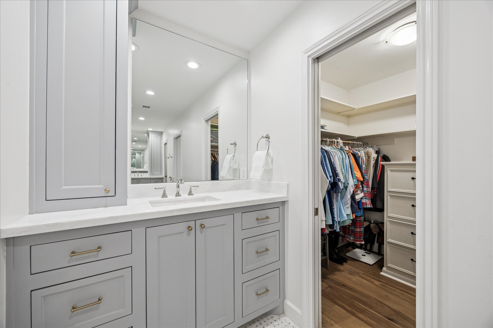 7906 Meadowbriar Lane Houston, TX 77063 - Photo 21 of 34 A peek into the opposite vanity and closet, featuring lots of storage and beautifully re-imagined cabinetry during the remodel.