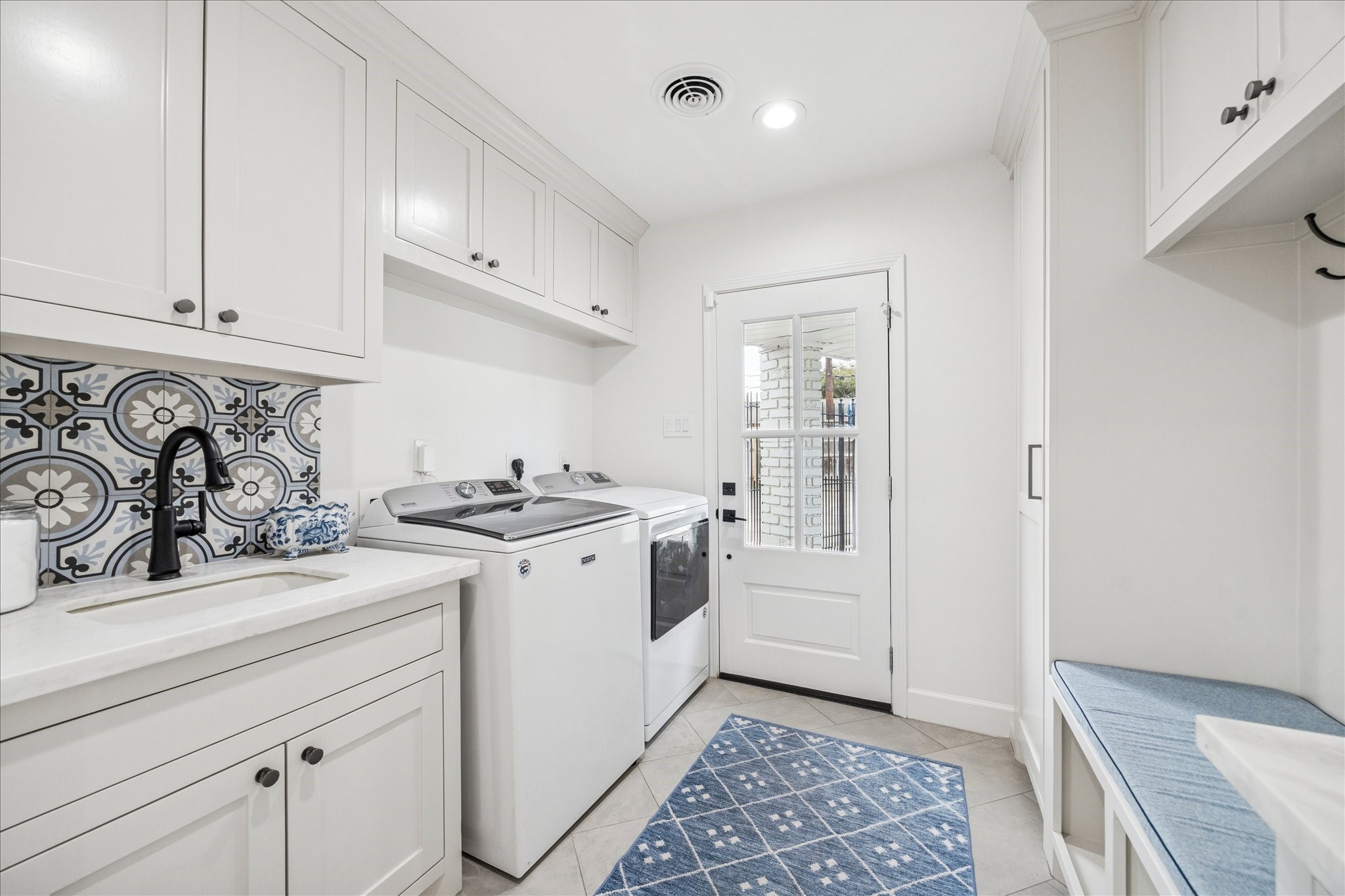 7906 Meadowbriar Lane Houston, TX 77063 - Photo 26 of 34 The laundry room is located off the kitchen with a sink and has lots of storage. It also features a drop zone, great for a busy family!