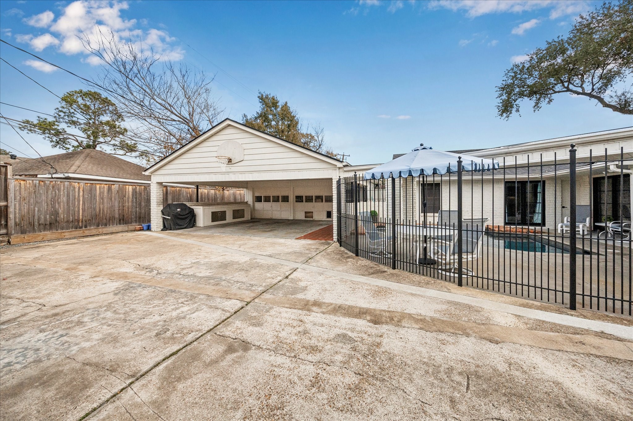 7906 Meadowbriar Lane Houston, TX 77063 - Photo 32 of 34 This oversized driveway space is the perfect place to play basketball, ride scooters, and other fun outdoor activities with your family. There is space for 2 cars under the covered carport, located in front of the garage apartment. This space can also double as an entertaining space. It features the perfect nook for your grilling and prepping.