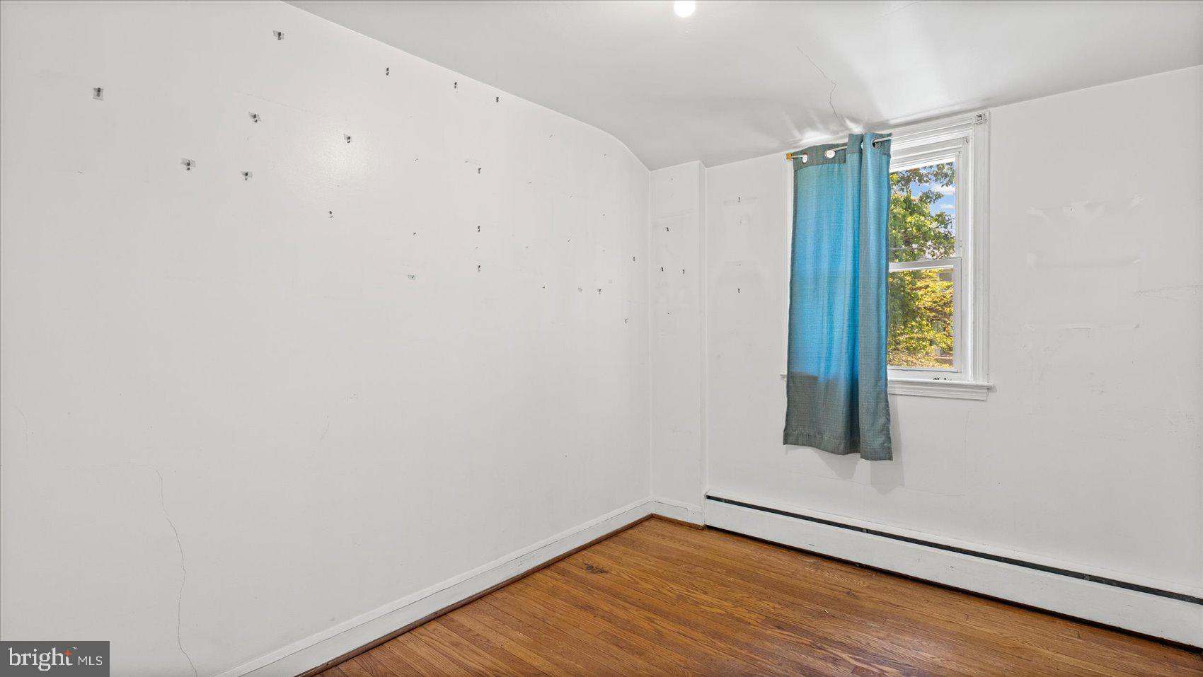 1805 Crestview Road Baltimore, MD 21239 - Photo 23 of 39 a view of an empty room with wooden floor and a window