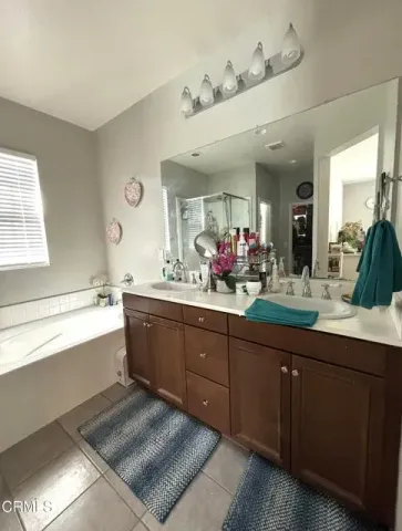 a spacious bathroom with a sink mirror and a bathtub