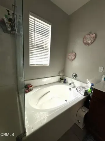 a bathroom with a tub and sink